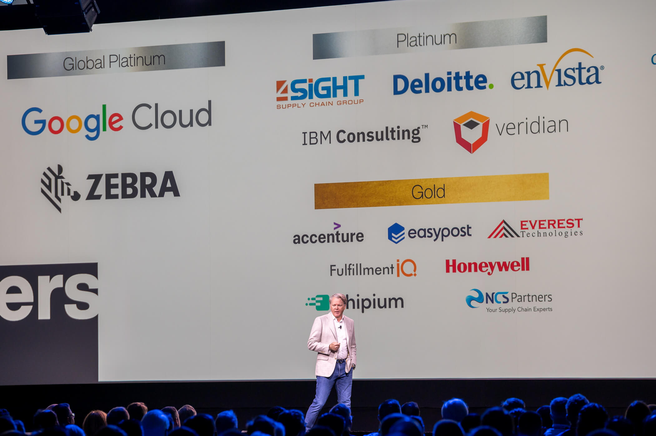 Image of a Eric Clark, CEO of Manhattan Associates at the 2025 Momentum Conference speaking about partnerships with Google and Shopify.