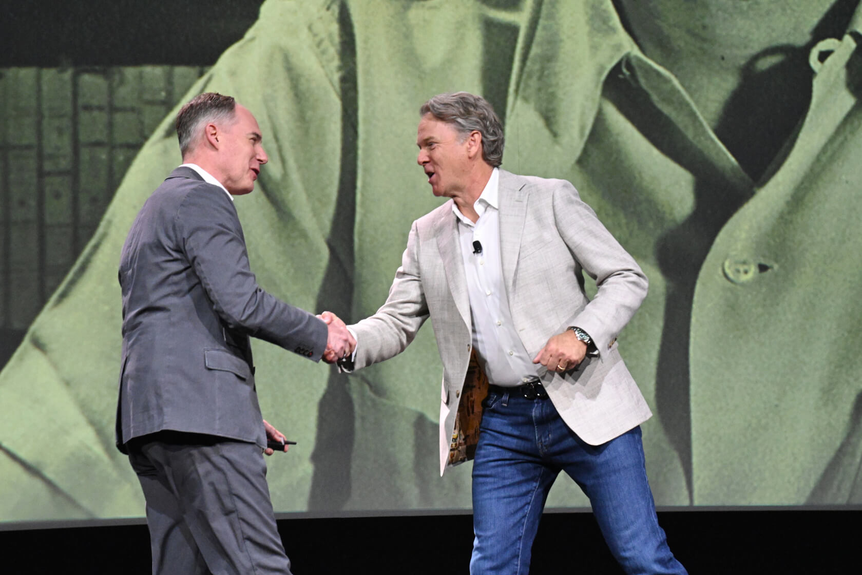 Image of Eric Clark, CEO of Manhattan Associates at the 2025 Momentum Conference shaking hands with speaker AJ Sutera, CTO Duluth Trading Company.